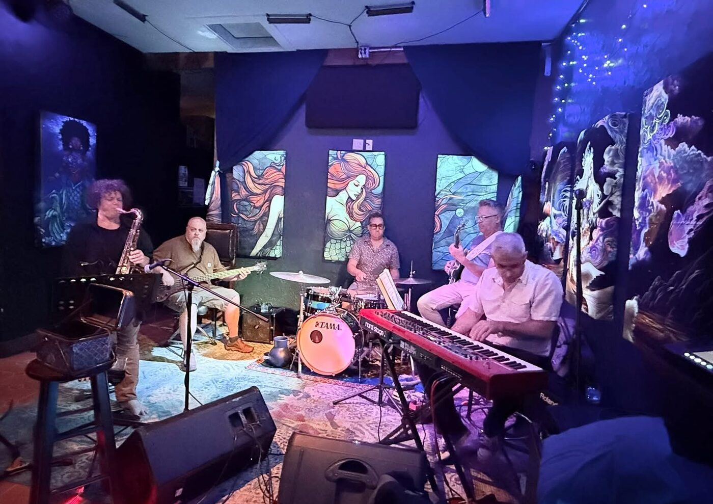 The Hot McGandhis on stage: saxophone, bass, drums, guitar and keys