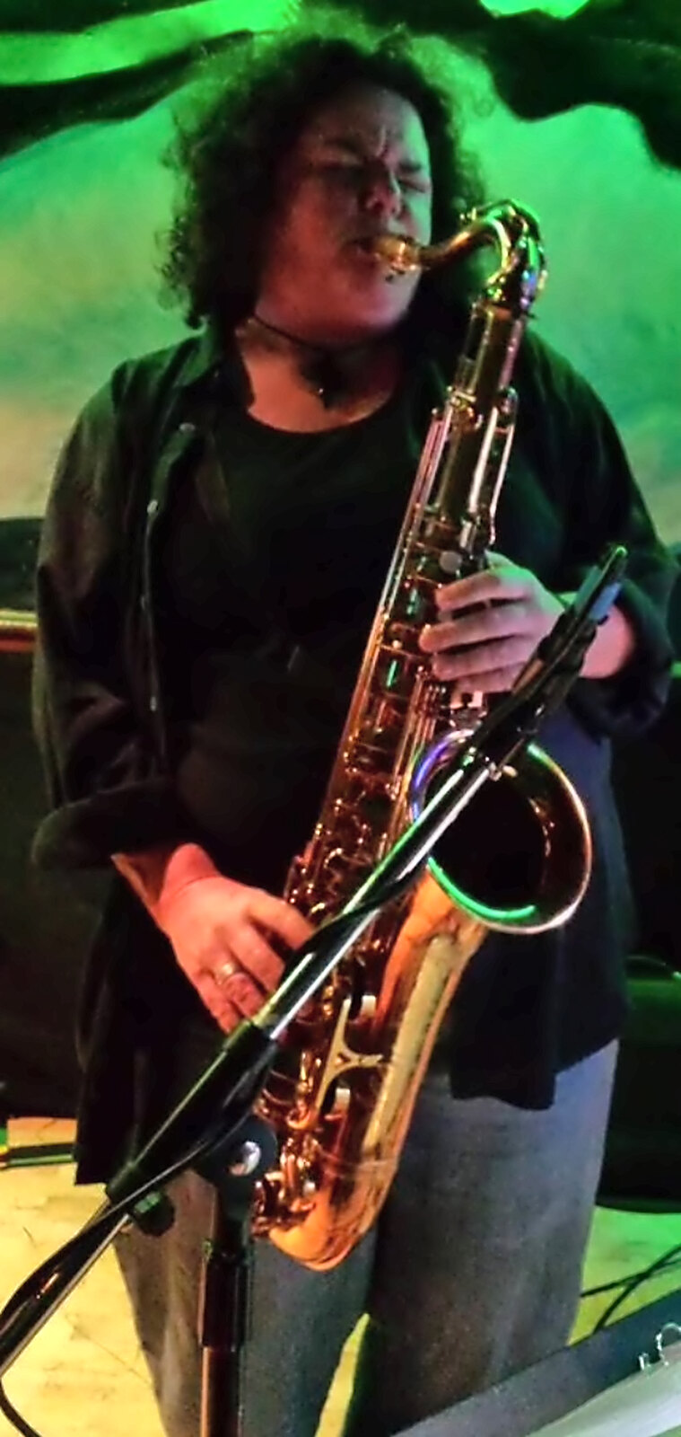 Tracy on tenor under green stage light